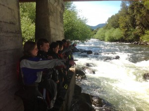 Students work together to scout a rapid on the Trancura River