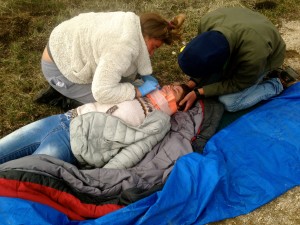 Two of our students, rescuers, tending to an "injured" patients during an afternoon simulation